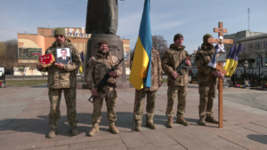 Церемонія прощання з Іваном . У руках побратимів: нагороди, портрет, прапор, Хрест