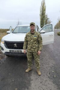 Сергій на фоні машинини в тилу